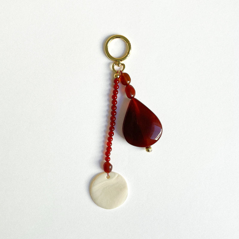 Handcrafted bag charm, keyring charm, belt loop charm. Made with carnelian and shell. Gold plated. 